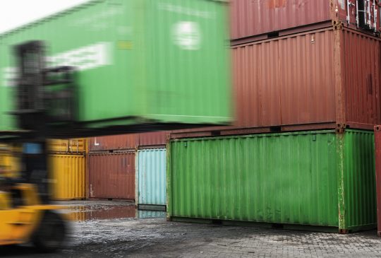 Forklift unloading a container box